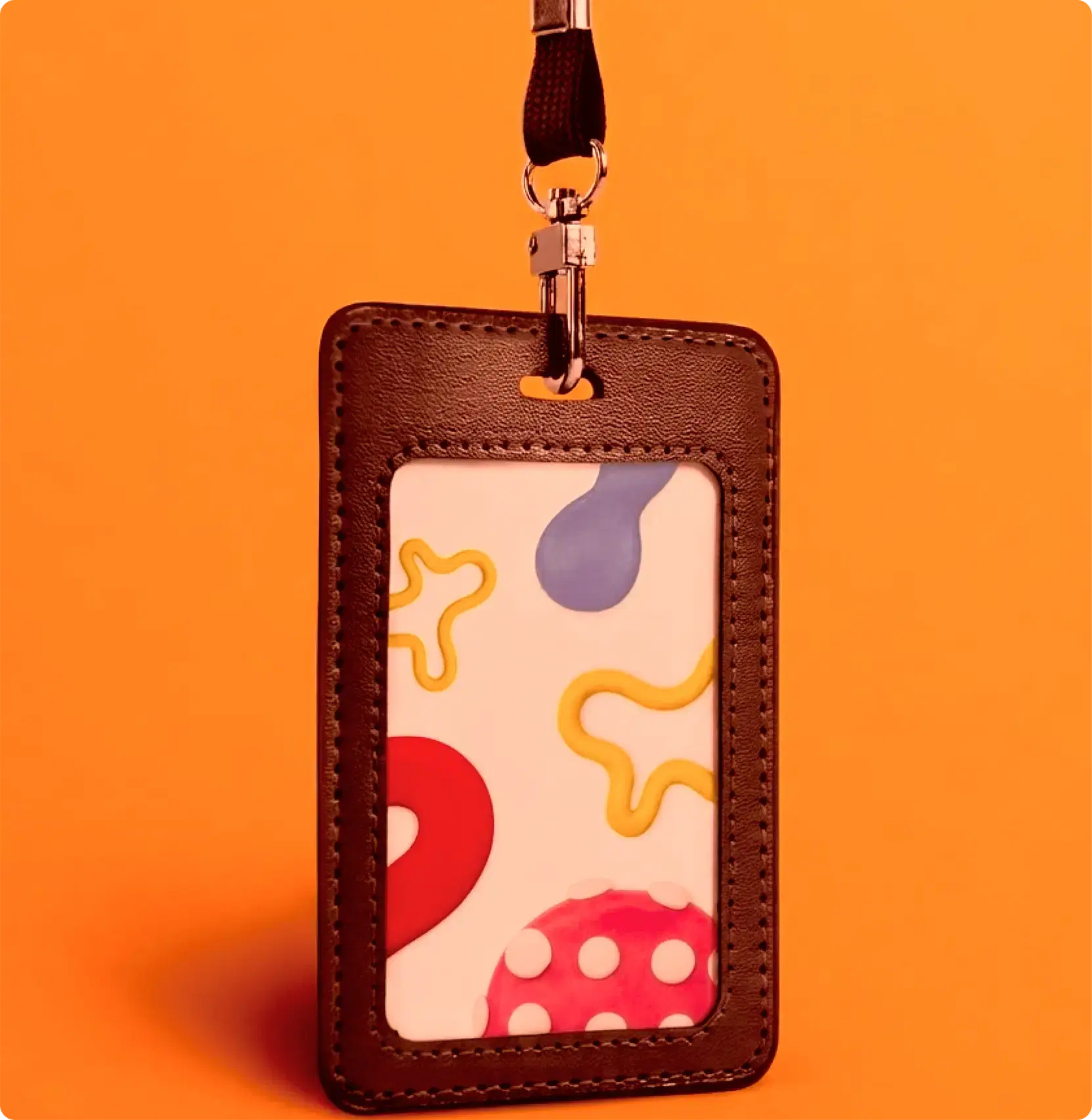 An identity card hanging from a lanyard against an orange ground